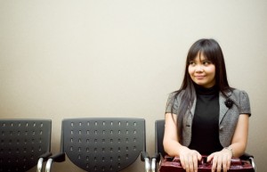 asian businesswoman sitting alone in a waiting room for an appointment